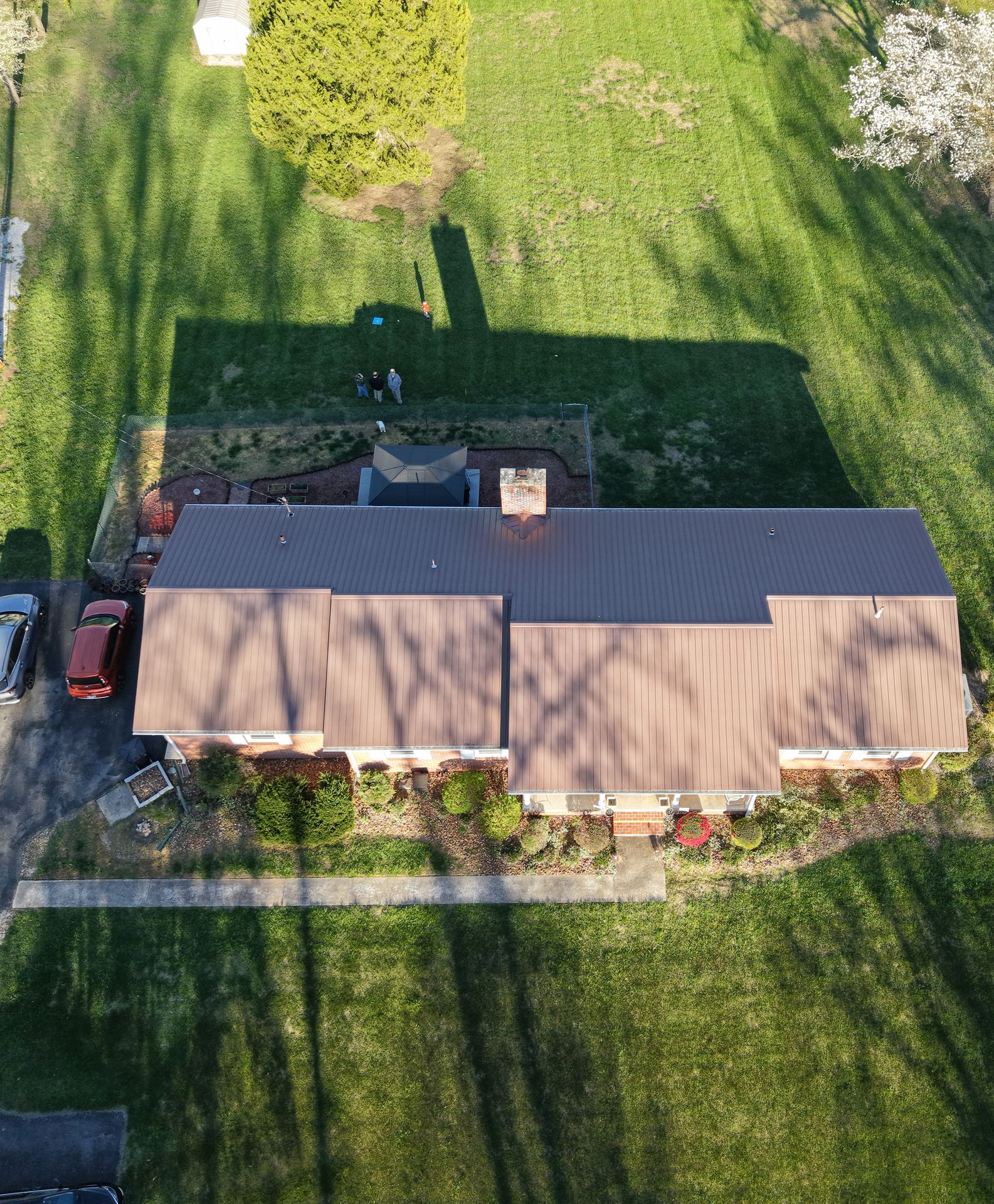 Aerial drone photo of a Louisville home's metal roof, backyard, and driveway captured for property documentation
